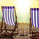 Two beach chairs facing the ocean