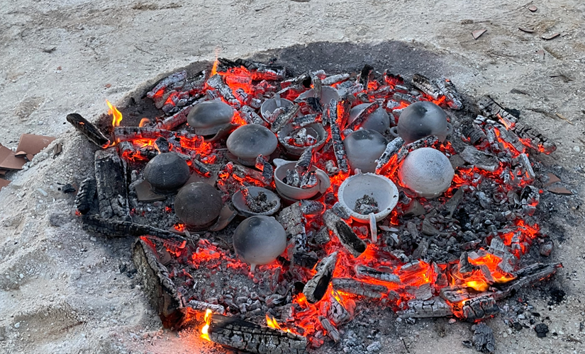 Image of clay pots on top of coals