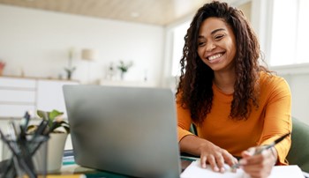 woman sitting in a chair looking at a computer screen