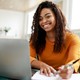 woman sitting in a chair looking at a computer screen