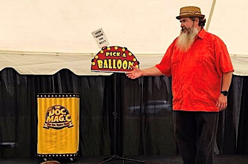 A magician performs magic tricks on stage