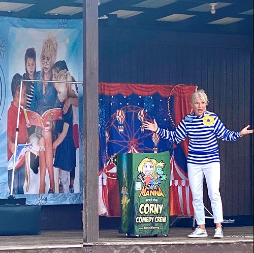 Judy Penuel of Dolly Parton's Imagination Library stands on a stage to lead a program