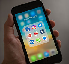 image of a phone with social media icons