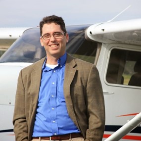 Alan Meyer stands next to an airplane at the Auburn Opelika Airport