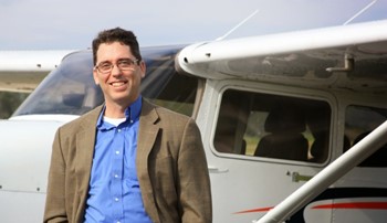 Alan Meyer stands next to an airplane at the Auburn Opelika Airport