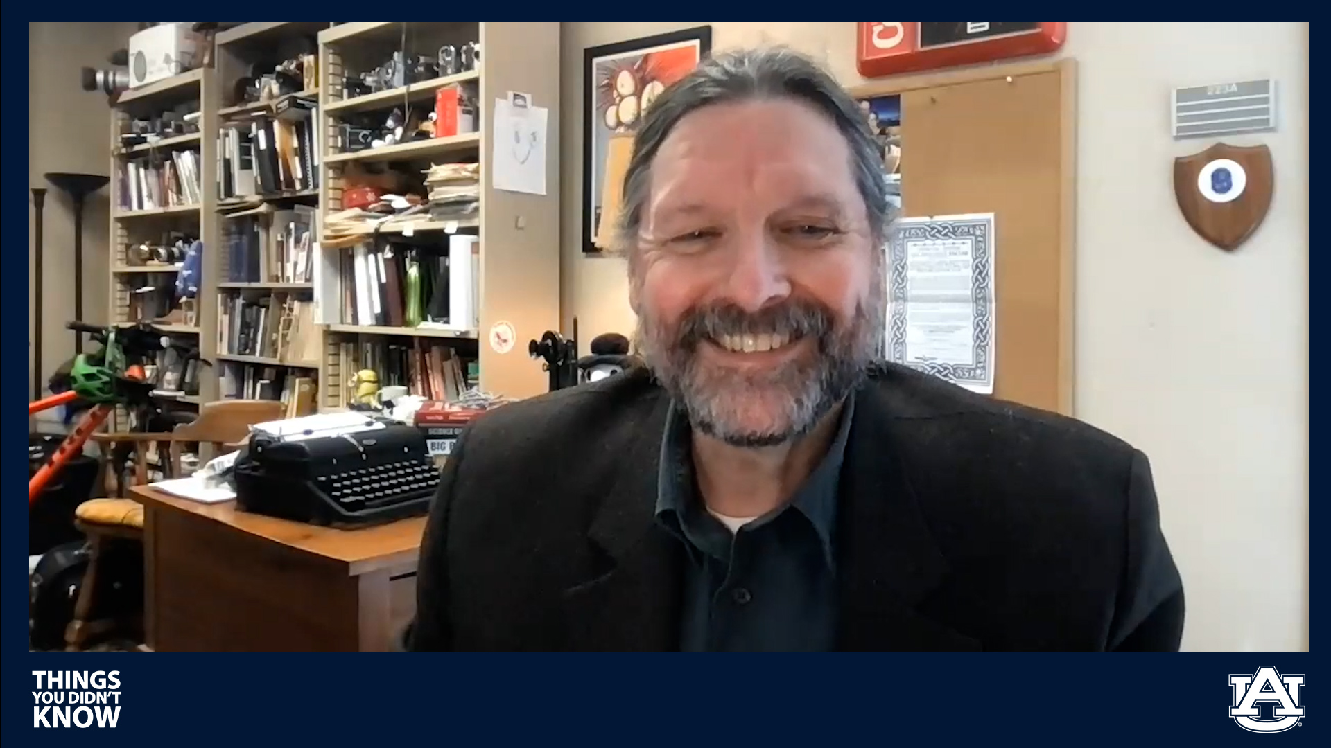 Professor Ed Youngblood smiles while recording a podcast