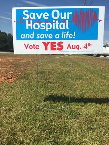 A sign that says &quot;Save Our Hospital and save a life! Vote YES Aug 4th&quot;