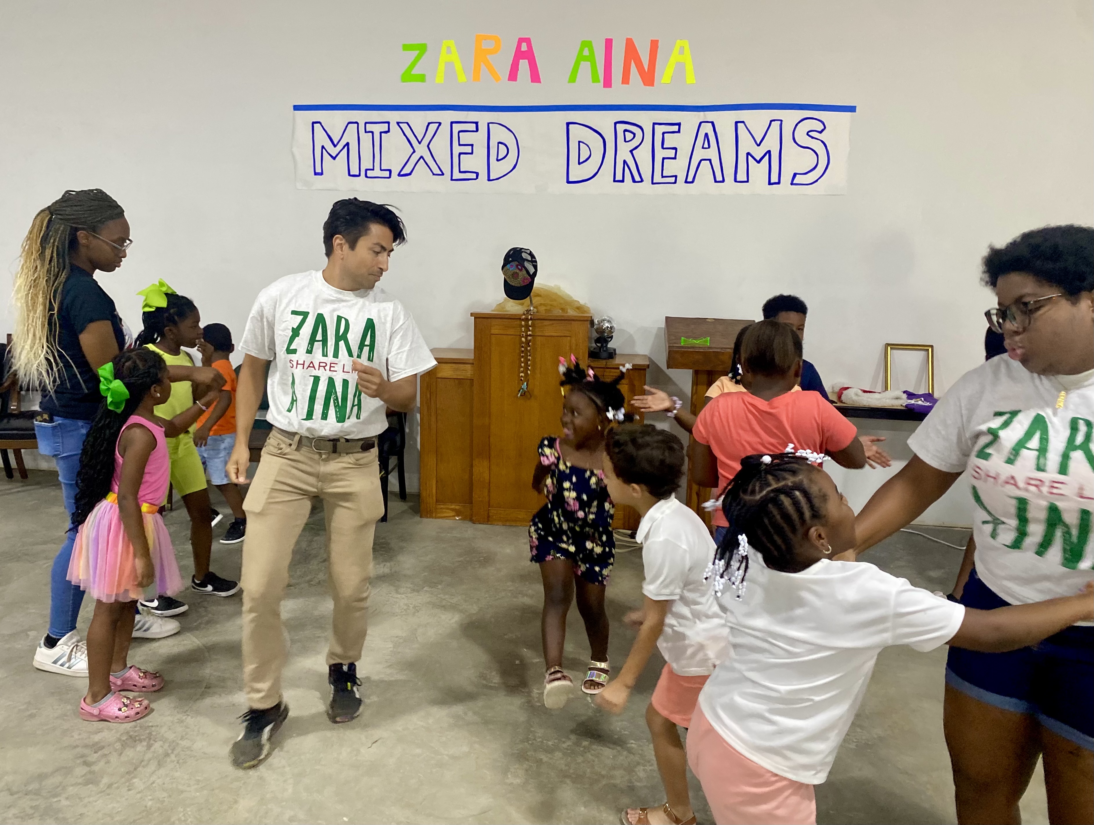 Zara Aina staff works with children