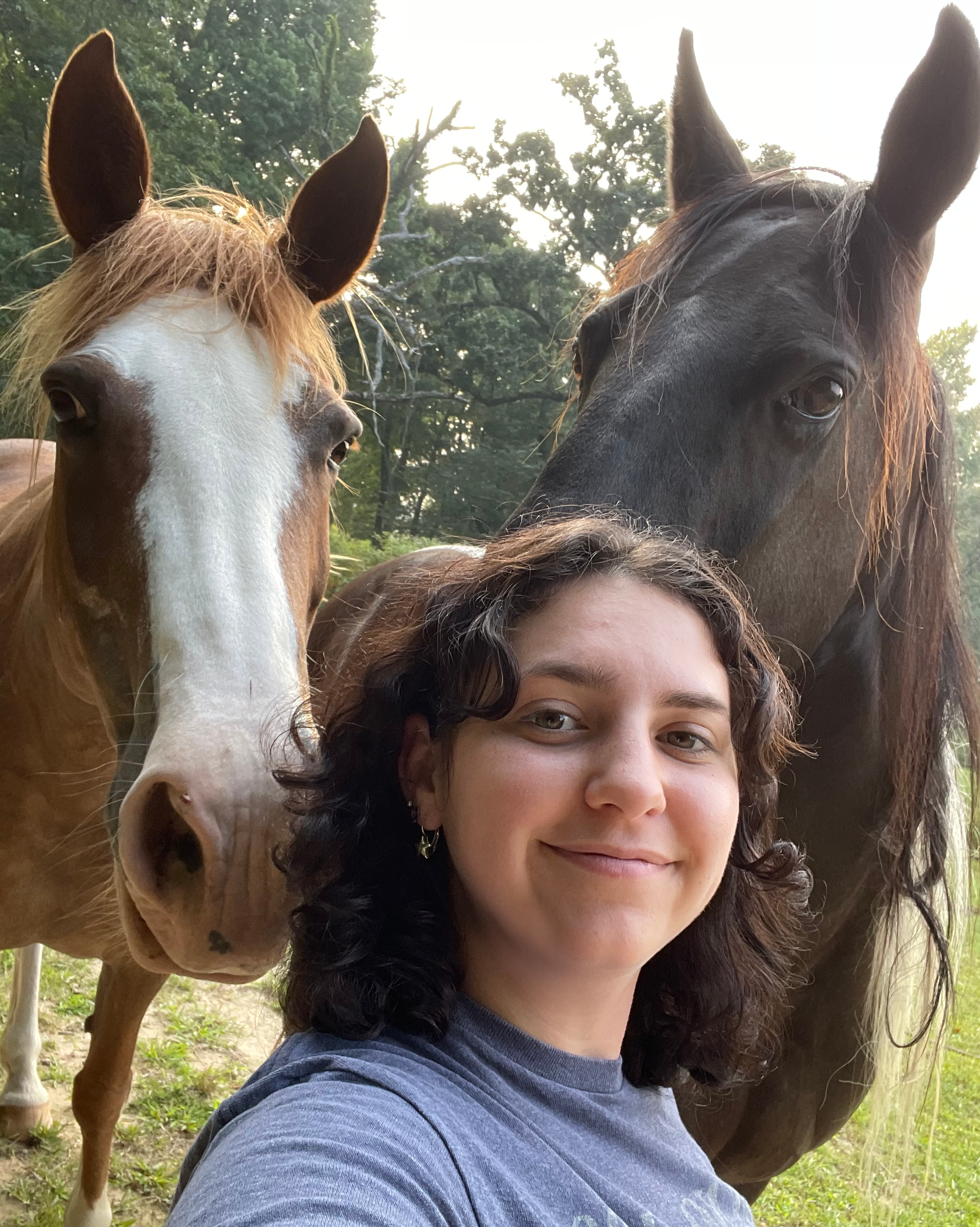 Payton takes a selfie with two horses