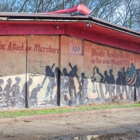 Artwork on the side of a building portrays the attack on marchers during Bloody Sunday in Selma