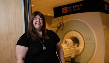 Jennifer Robinson standing in front of MRI machine