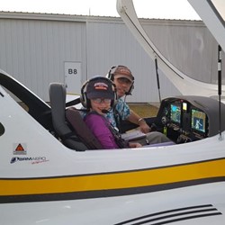 Alan Meyer and his daughter sitting in an airplane 