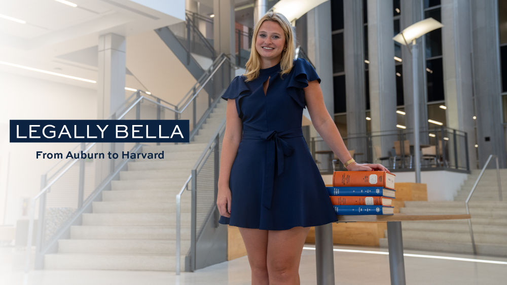Isabella Dee with books in the RBD Library at Auburn