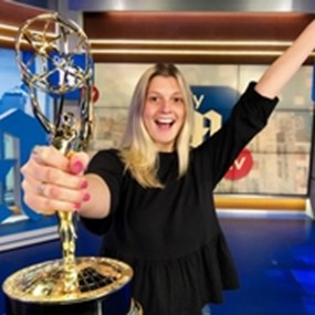 Julia Murphy holds an Emmy