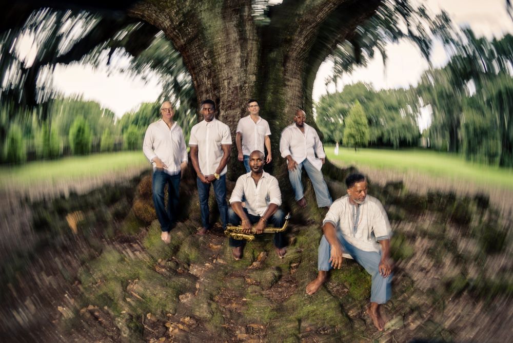 The New Creative Collective poses under a tree