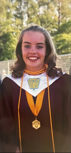 Becky Williams poses for a picture donning graduation attire