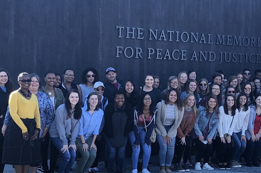 Social work class students standing in front of the National Museum for Peace and Justice