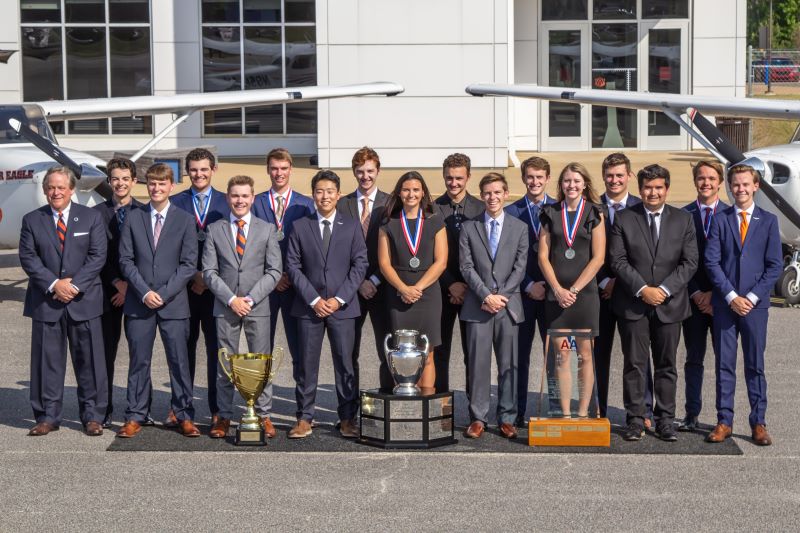 War Eagle Flying Team members stand with trophies at the Auburn Airport