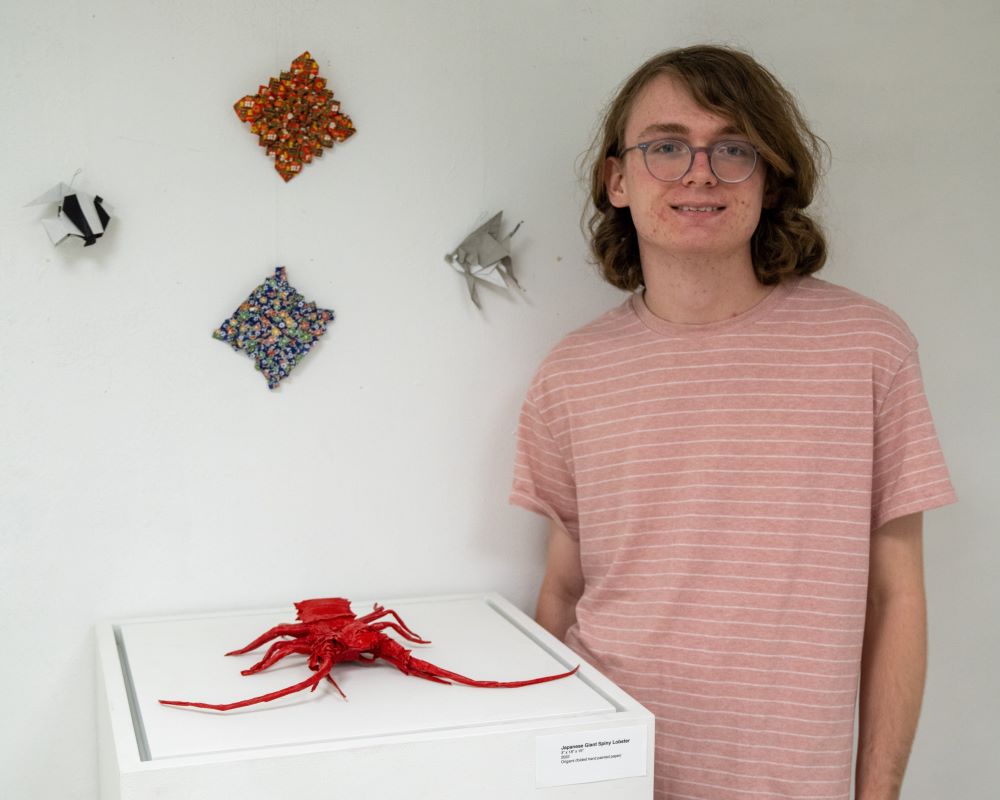 Collin Crowder with origami lobster
