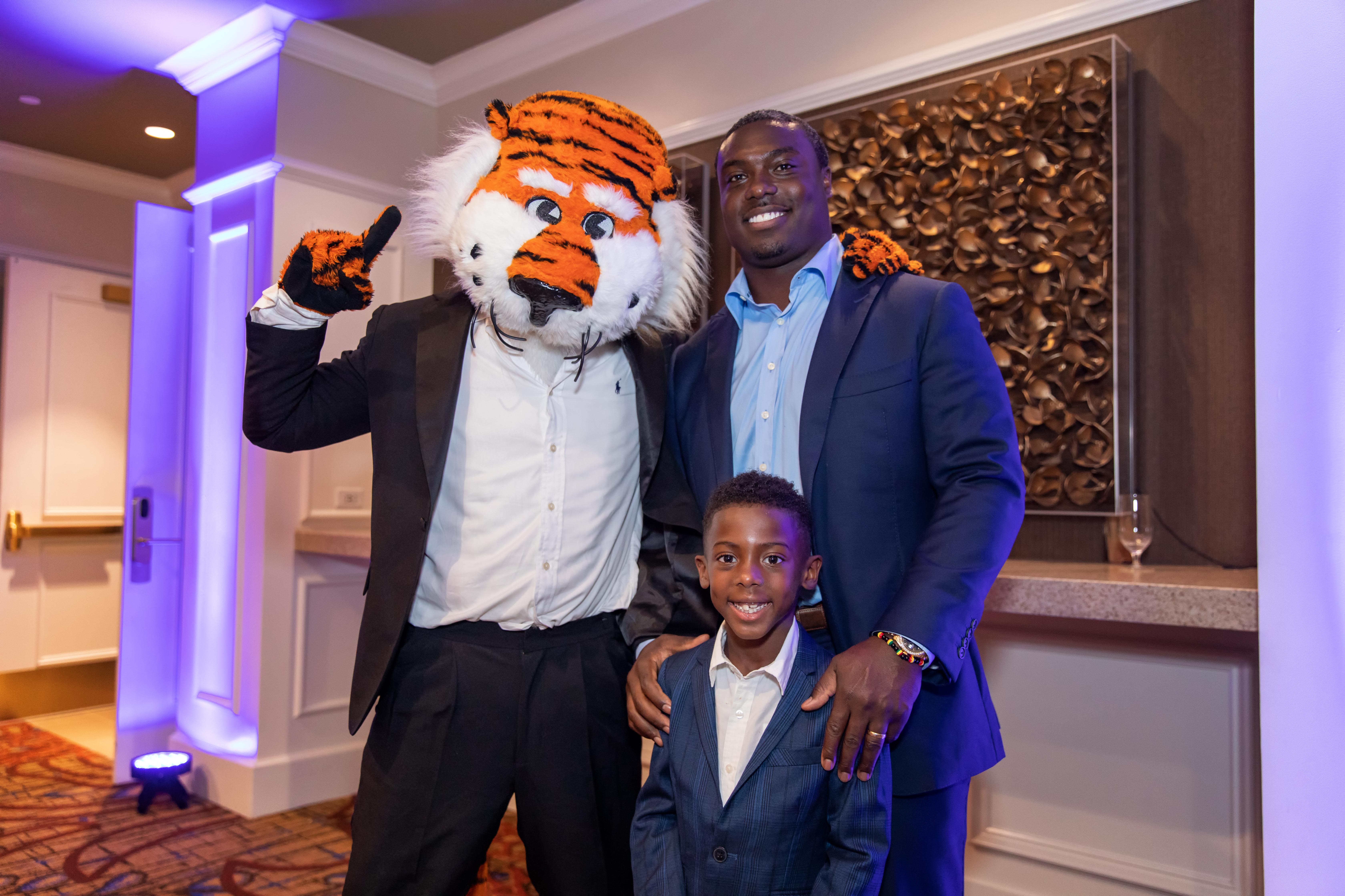 Ronnie Brown with his son and Aubie during Black Alumni Weekend