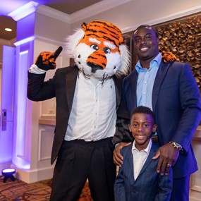 Ronnie Brown with his son and Aubie during Black Alumni Weekend