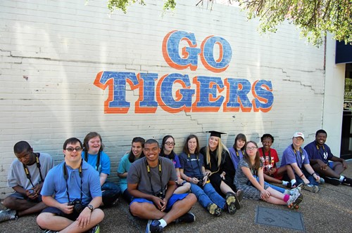 Students sitting in front of "Go Tigers" wall by J&M Bookstore
