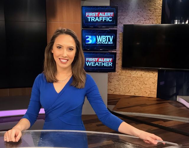 Amanda Foster sitting at news desk