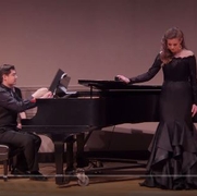 women singing in front of piano accompaniment