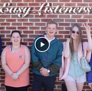 FIVE STUDENTS IN FRONT OF BRICK WALL